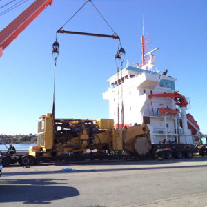 Global relocation project of Komatsu 830E, truck body being loaded onto cargo ship