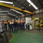 H-E Parts Engineering team in workshop alongside new machinery to increase capability